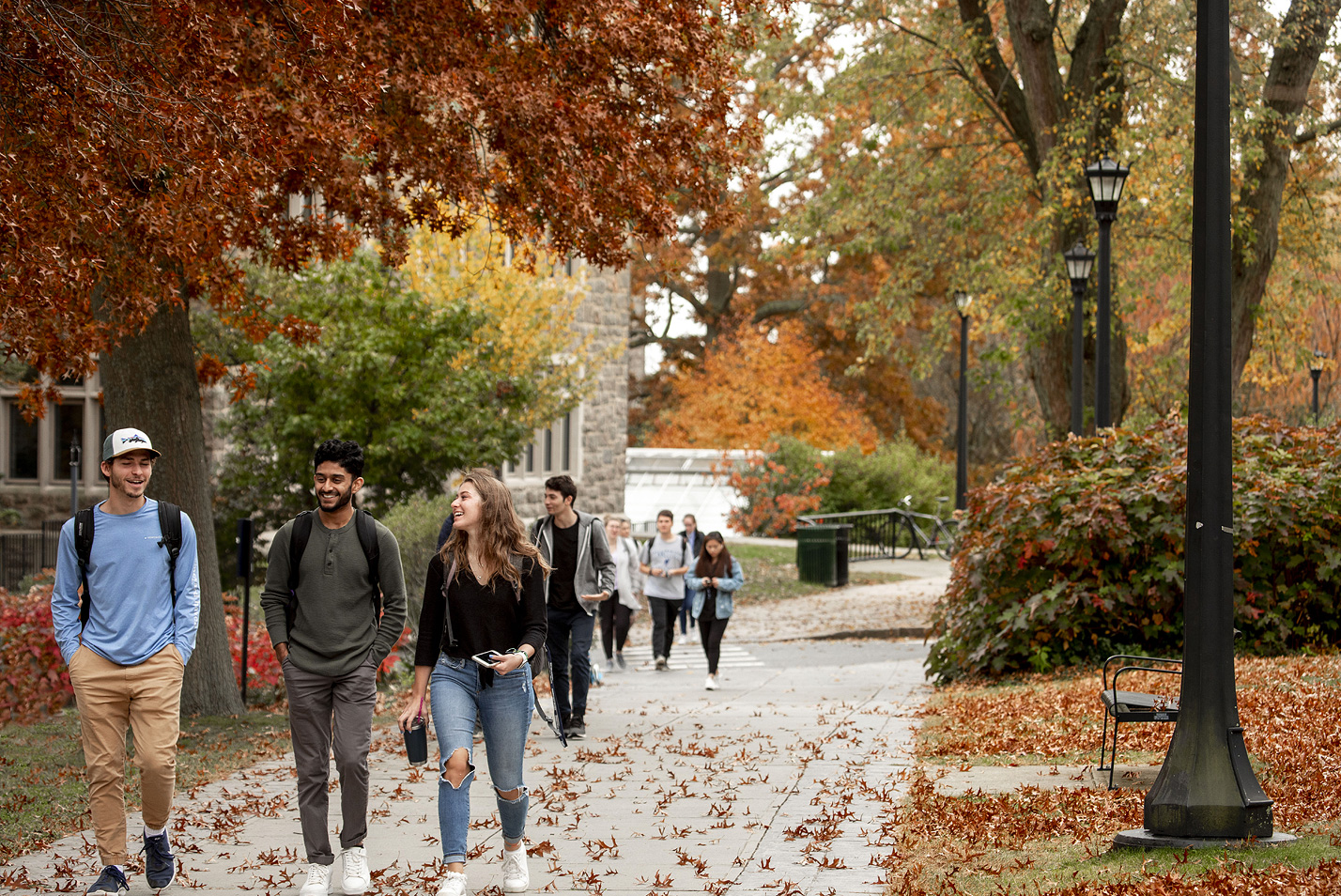 Students walking though campus in the fall