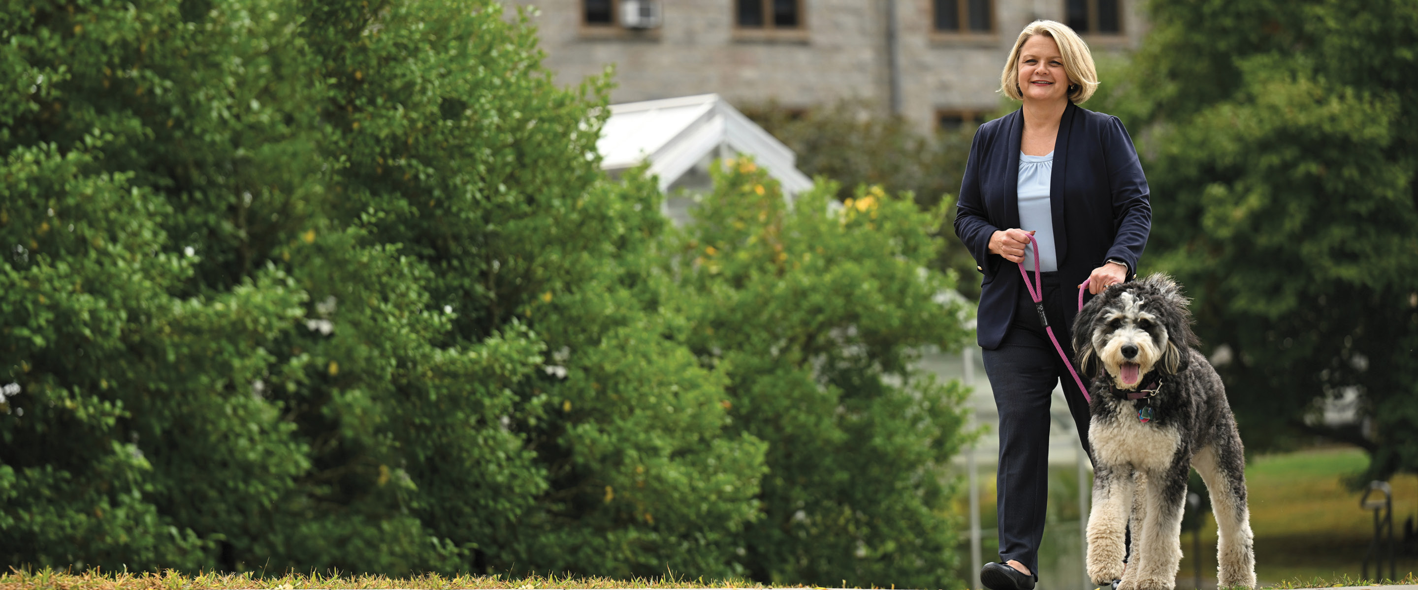 President Chapdelaine walking her dog through campus