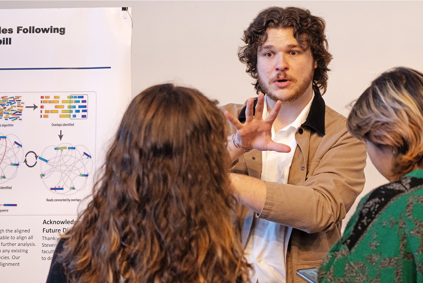 A presenter details his work at a Summer Science poster session during Fall Weekend