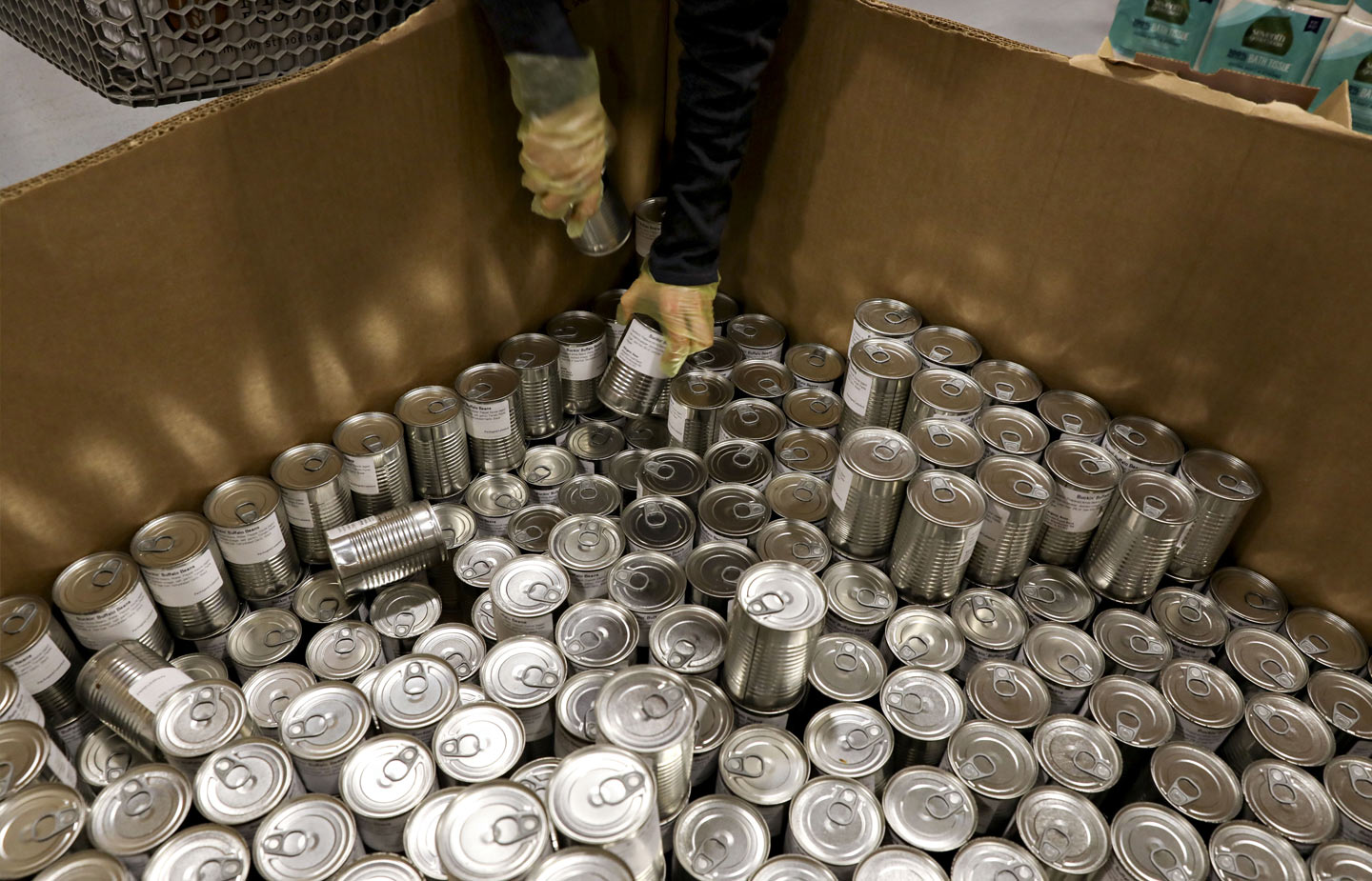 Image of cans being unloaded from a delivery box