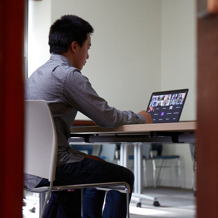 Student at computer during the virtual All-College Symposium