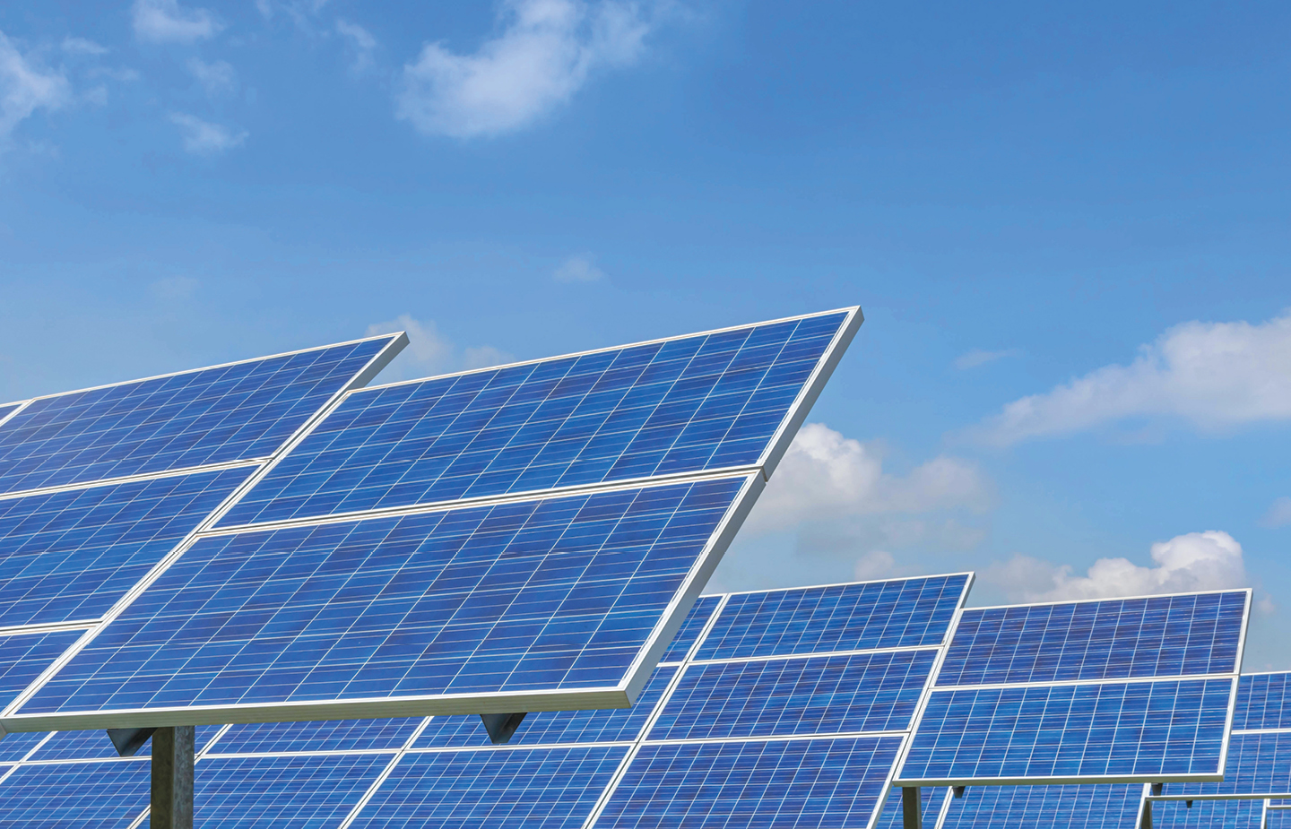 An image of solar panels under a blue sky