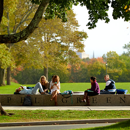 Students sitting and talking on Tempel Green. 