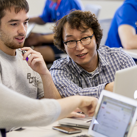 Computer Science Professor S. James Lee, right, works with a student in his 