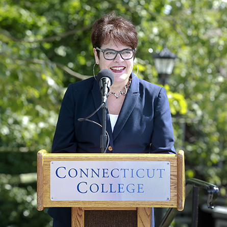 President Katherine Bergeron speaks at a ribbon-cutting ceremony marking the official reopening of Unity House and the completion of a road extension project that connects the north and west parts of campus.