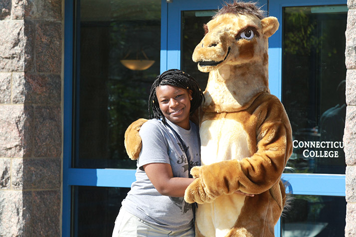 A student poses with the Camel mascot