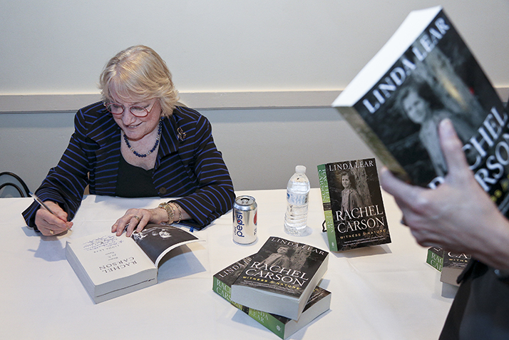 Linda Lear signs copies of her books. 