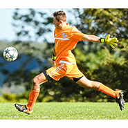 An action shot of men's soccer goalkeeper AJ Marcucci
