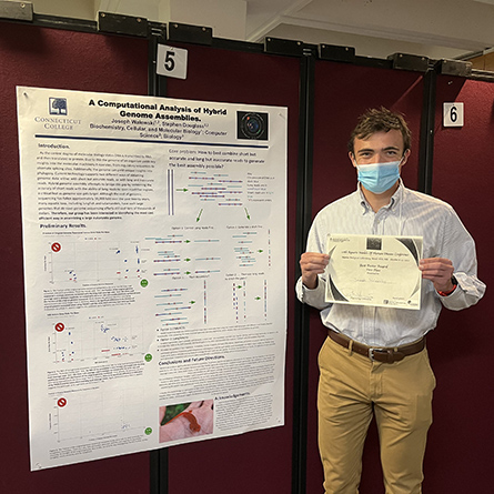 Joseph Walewski '23 with his poster and award at the conference.
