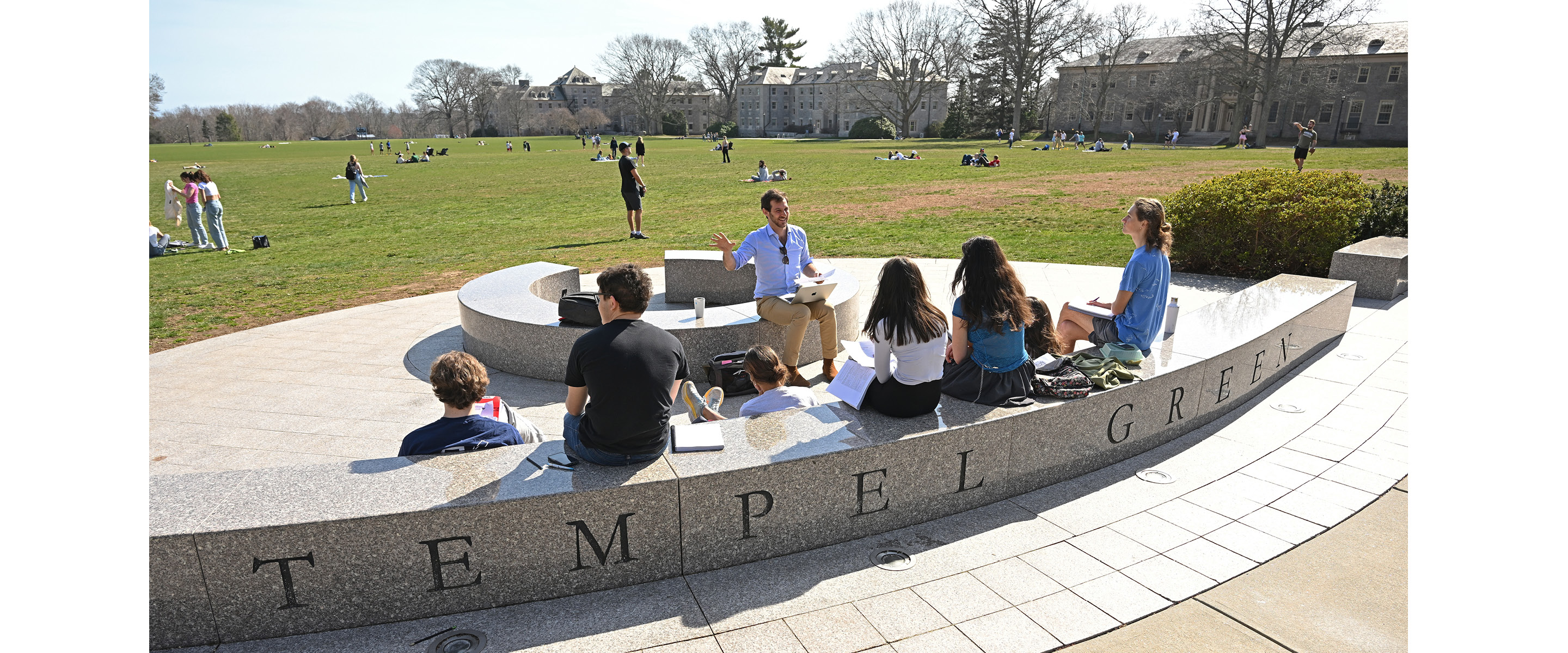 A teacher instructs students on Tempel Green