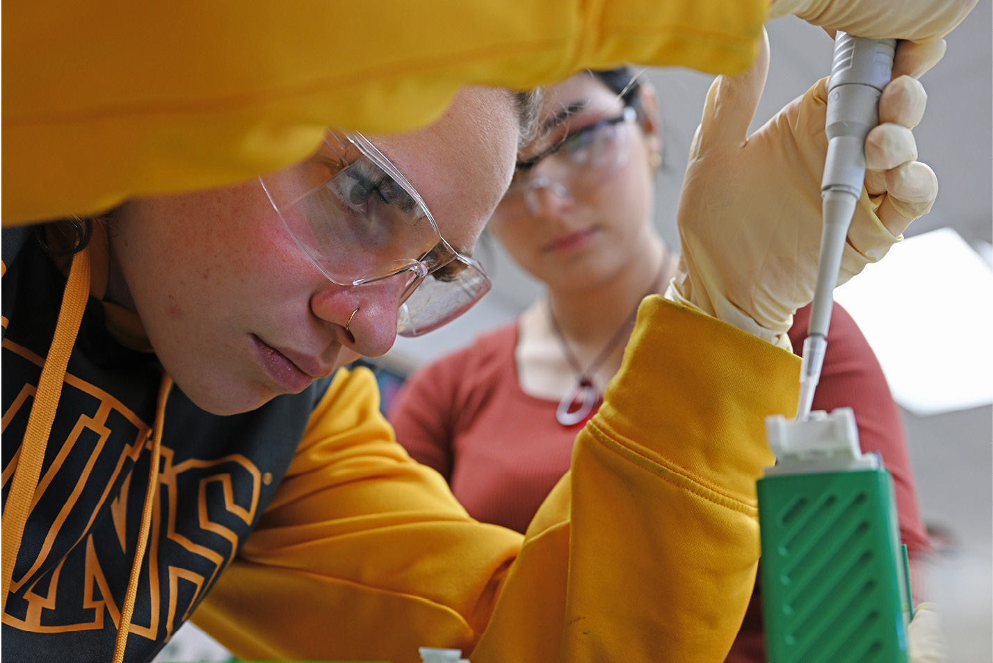 Close-up of students with safety glasses doing chemistry