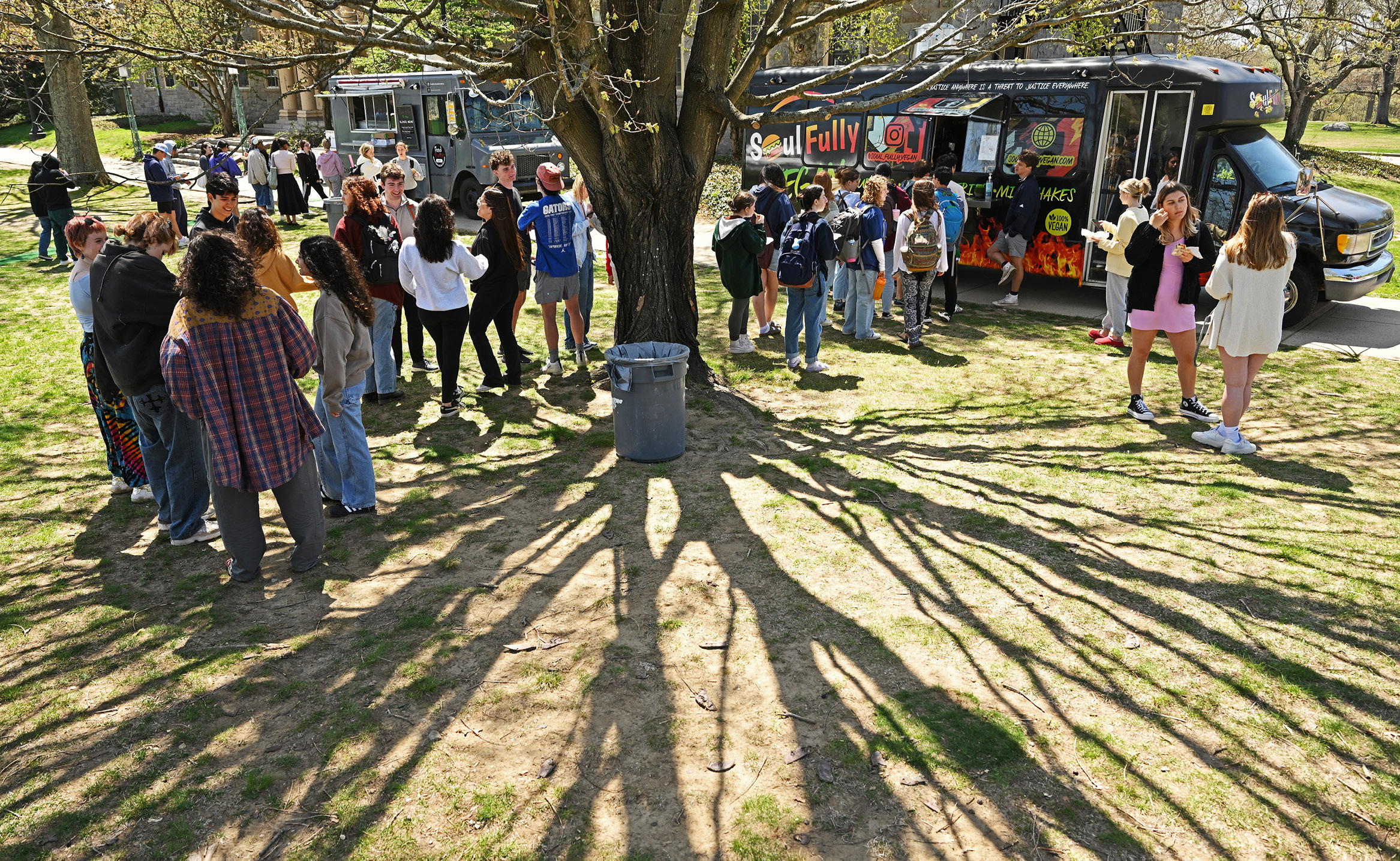 Students enjoy food from Food Trucks during Earth Day on Tempel Green