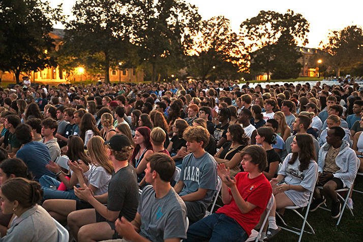 New students gather on Tempel Green as the sun sets on Arrival Day.