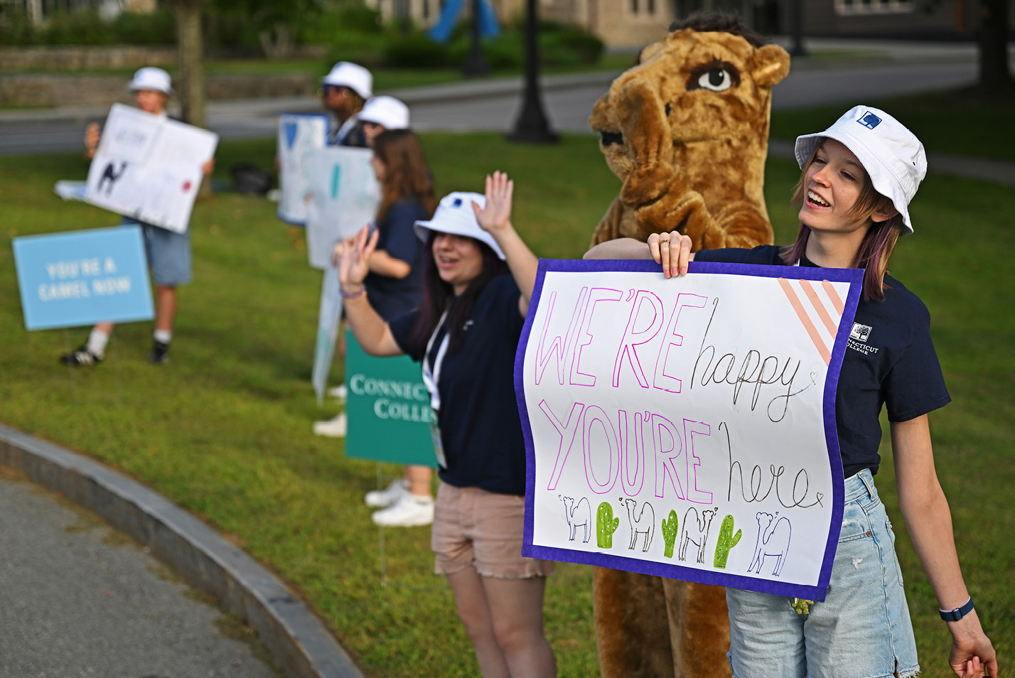 The camel mascot and other helpers welcome new students to campus.