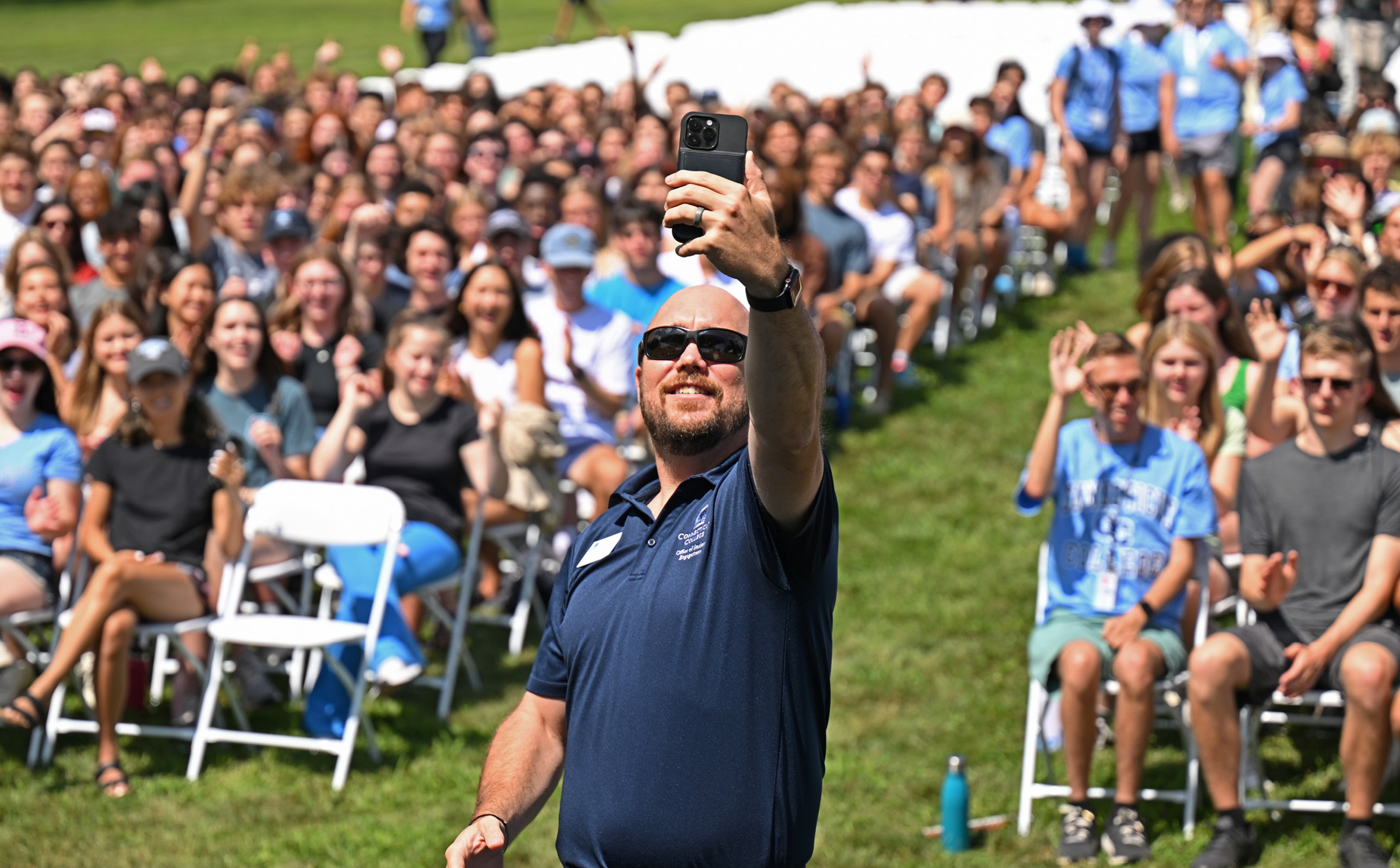 Assistant Dean Of Student Engagement And New Programs Geoff Norbert takes a selfie with a crowd of students