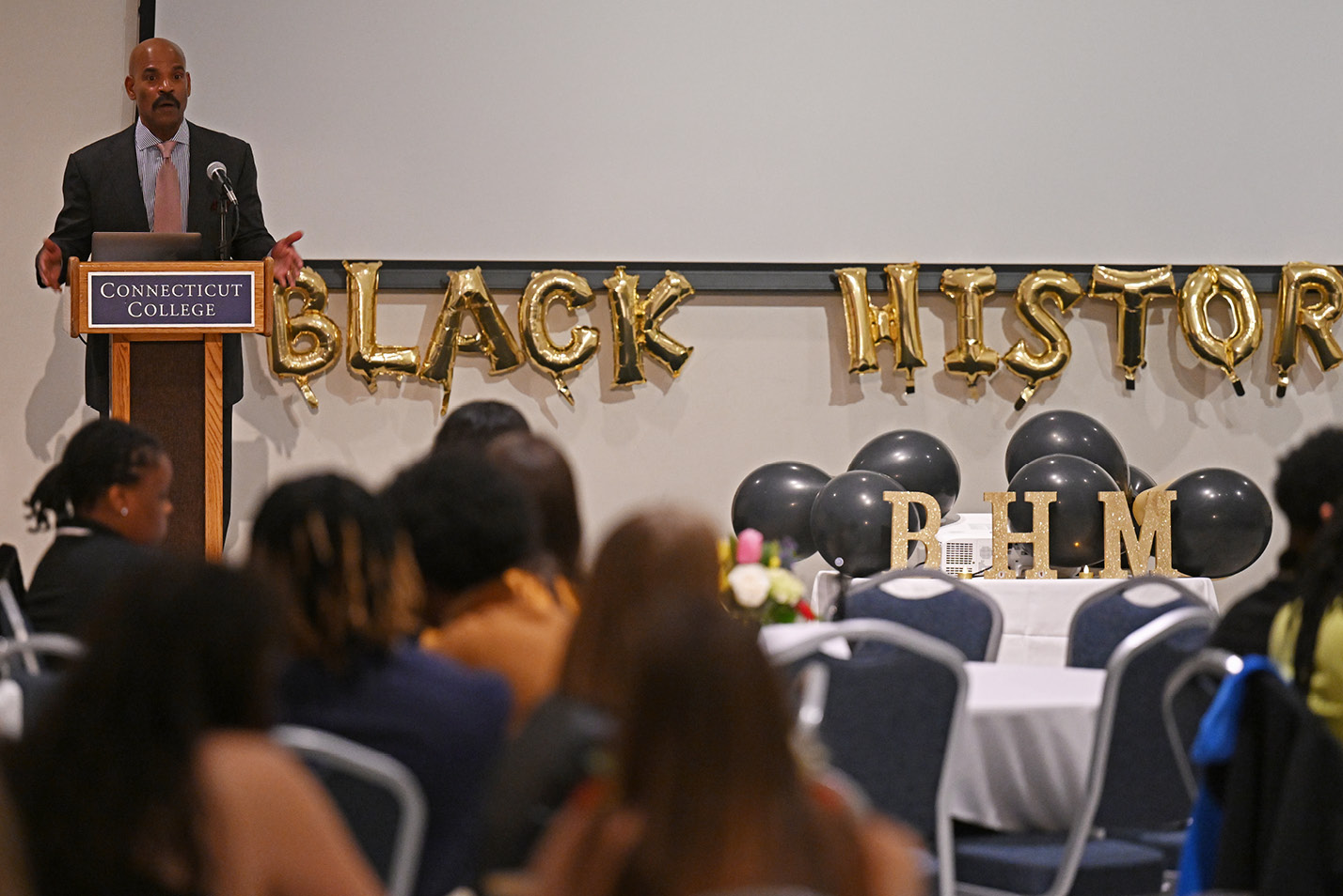 VP of Human Resources Reginald White addresses the crowd at the Black History Month Gala in the 1962 room.