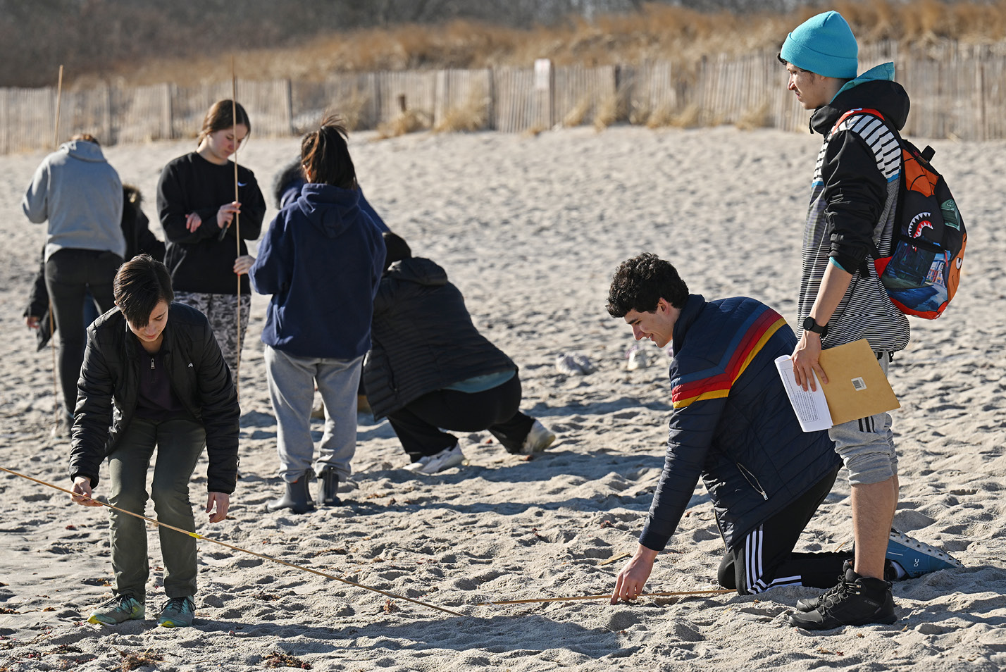 Abigail Haan ’26, Jamie Sussman ’26, and Kian Miranda-Rodriguez ’26 take measurements along a transect on Waterford Beach. This was the first off-campus outing for the class comprised entirely of first-year students interested in studying biology.