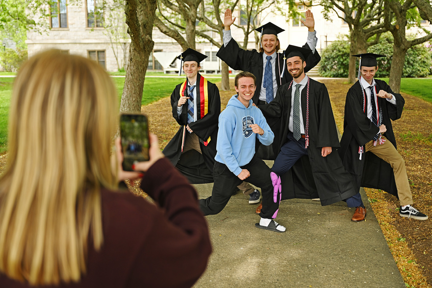 Katherin Rubel ‘24 takes photos of a group of senior friends Friday, May 19, 2023 under the Fanning Hall cherry trees.