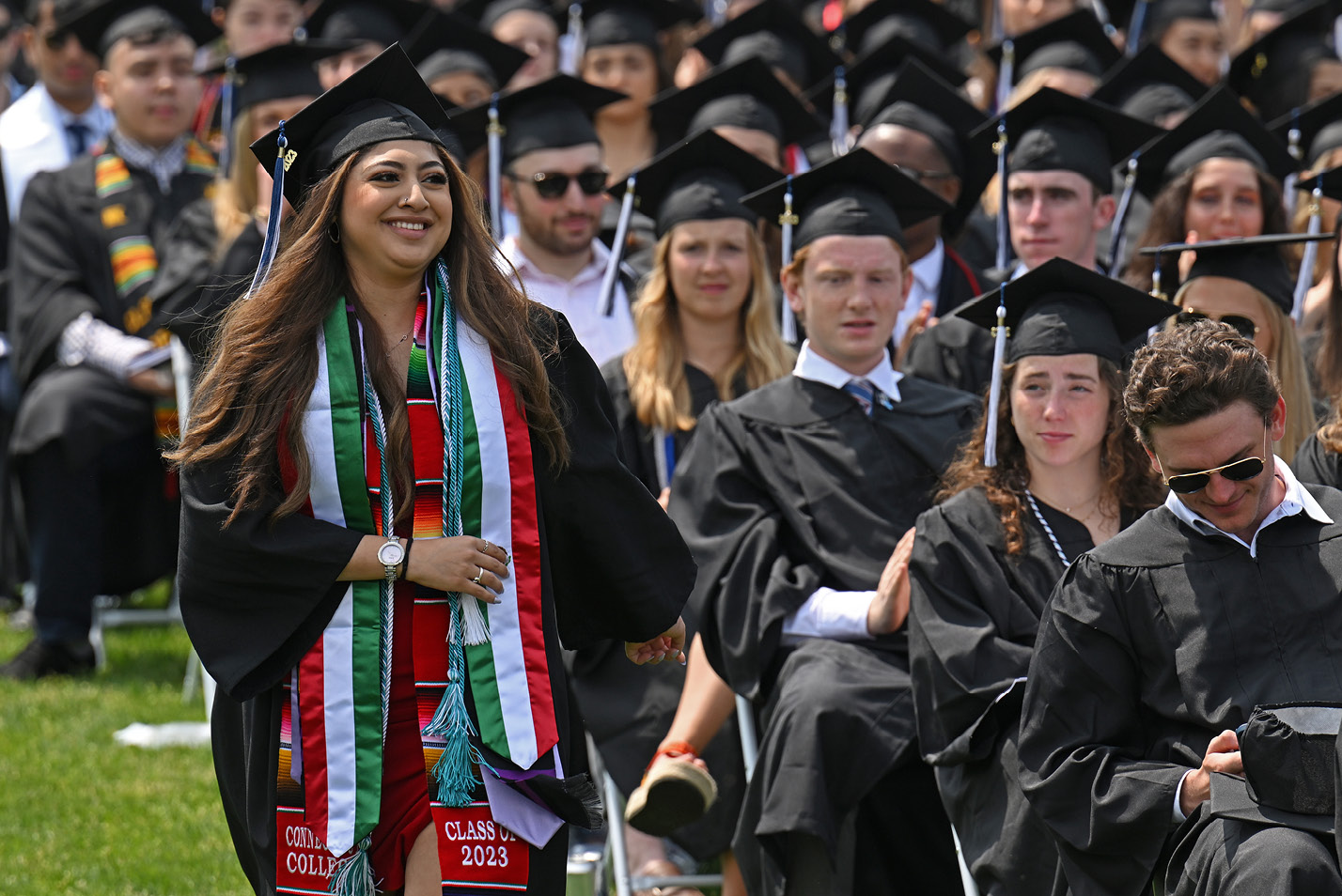 A student walks to receive her diploma at Commencement 2023.