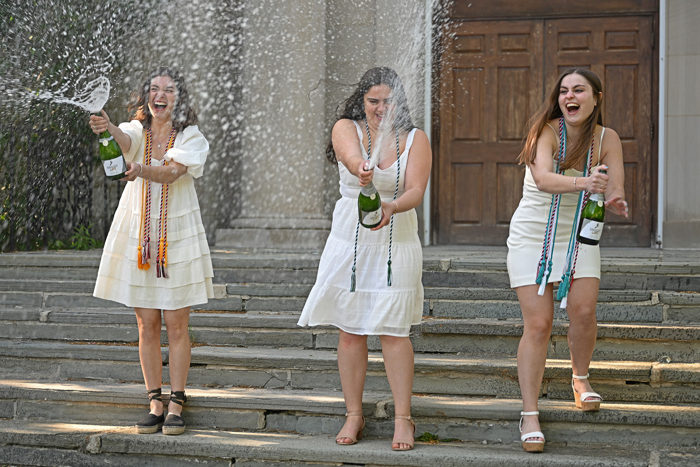 Students spray champagne to celebrate Commencement 2023