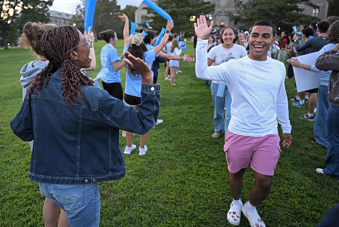 Students high five each other