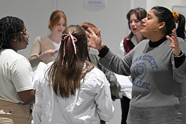 Professor Tess Cruz '16, right, works with student actors during a rehearsal of Urinetown.