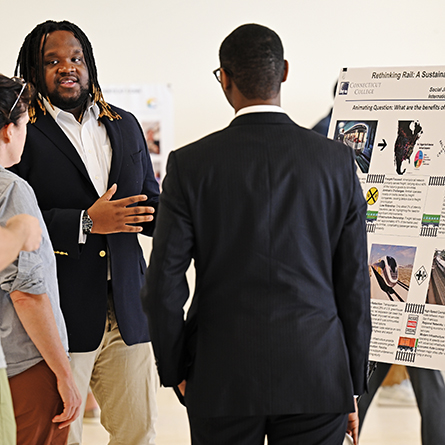 Zale Peart '25 presents his poster at the All-College Symposium