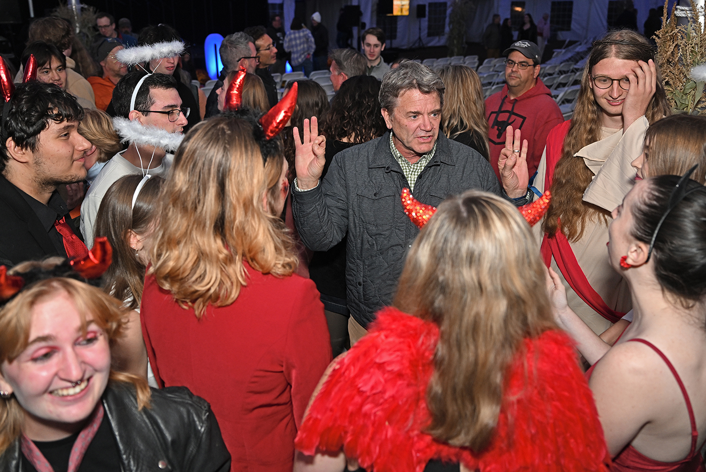 A celebrity guests speaks with college a cappella groups following their concert.