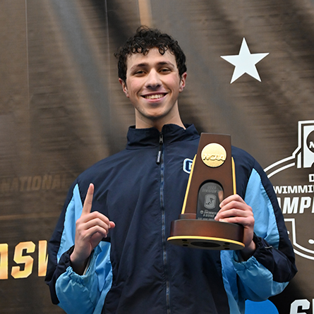 Justin Finkel holds the NCAA Championship trophy for the 500 free