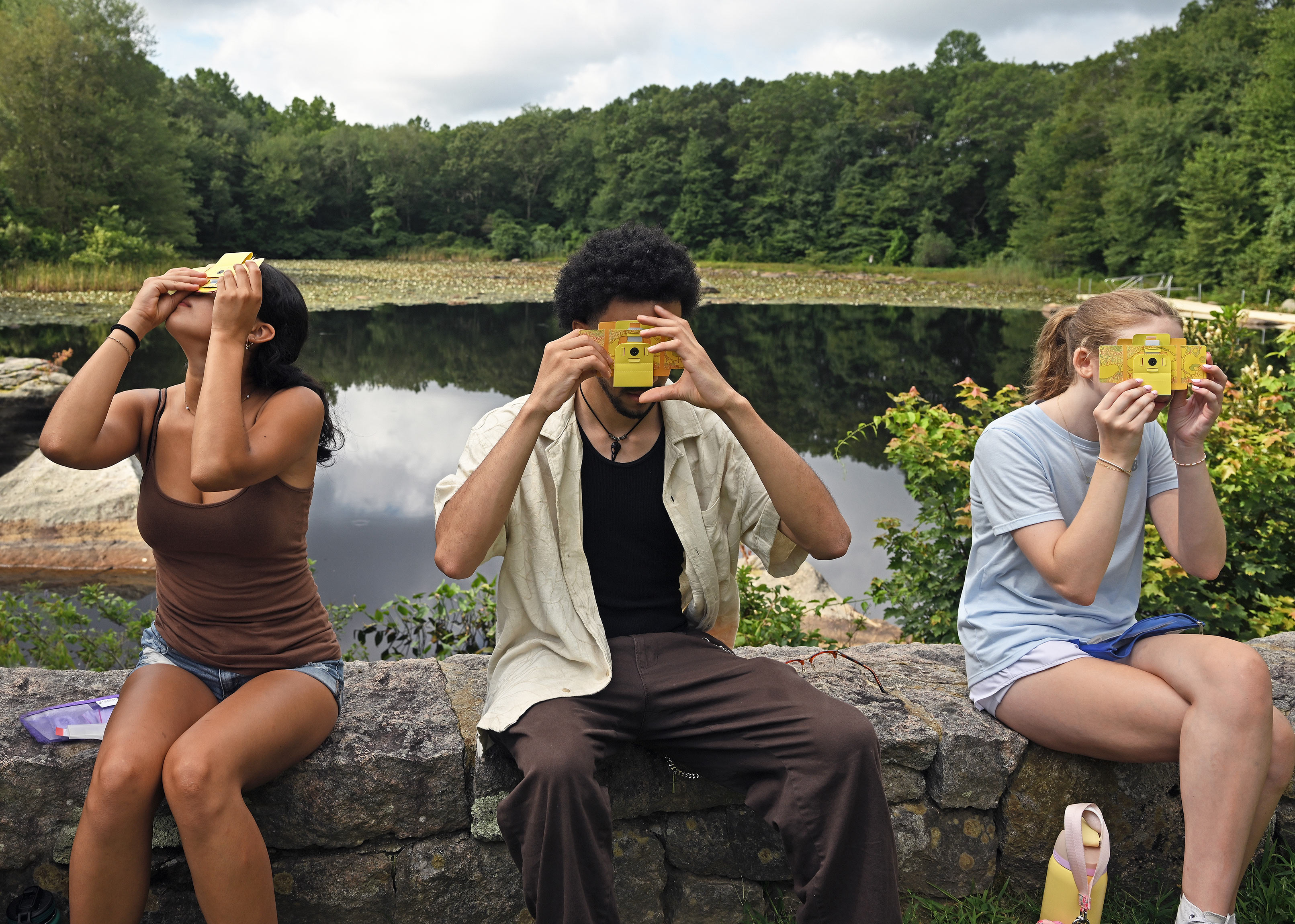 First-year students in the Science Leaders pre-orientation program use Foldscope cardboard microscopes to examine samples gathered from the Arboretum pond.