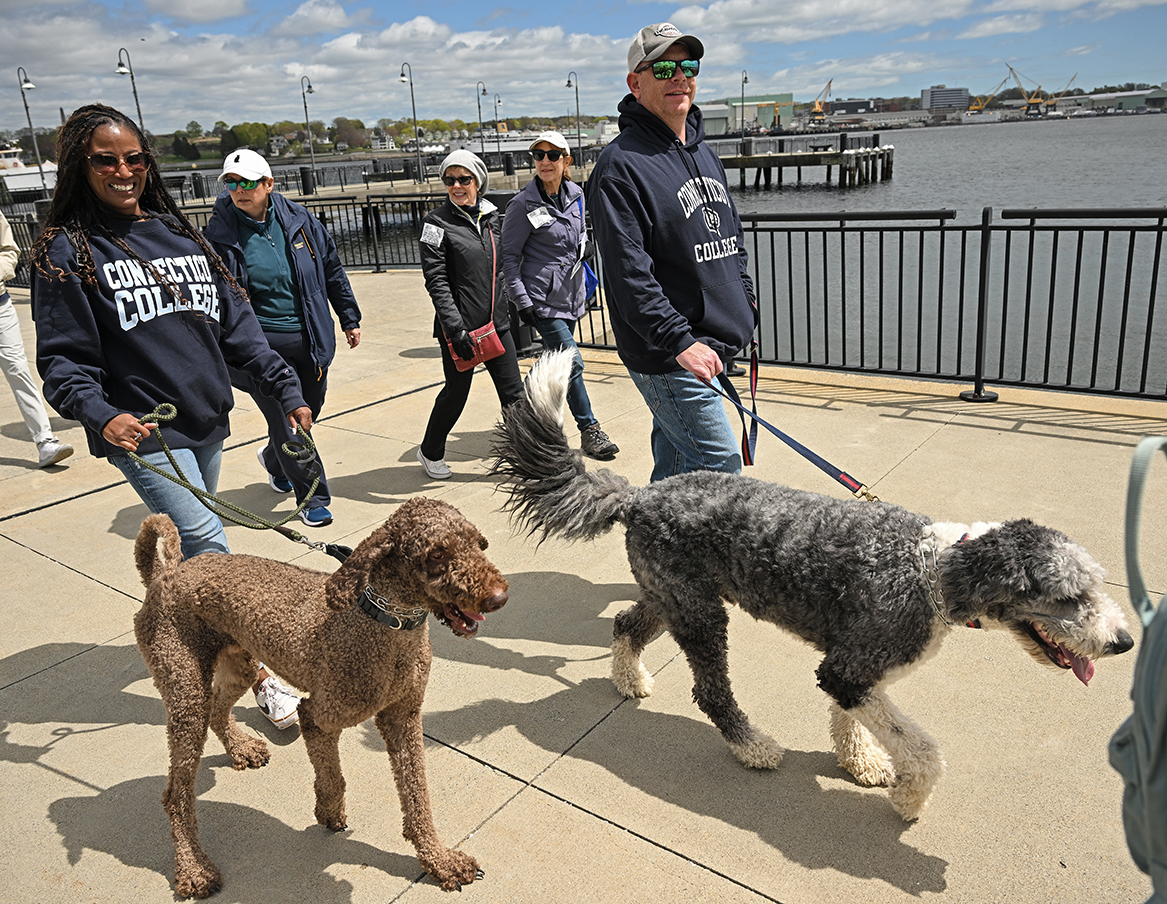 A staff member and her partner walk with their two dogs as they participate in the Walk to End Homelessness.