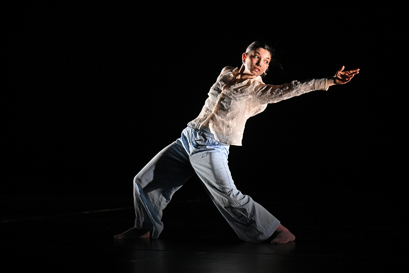 A dancer performs a solo on stage.