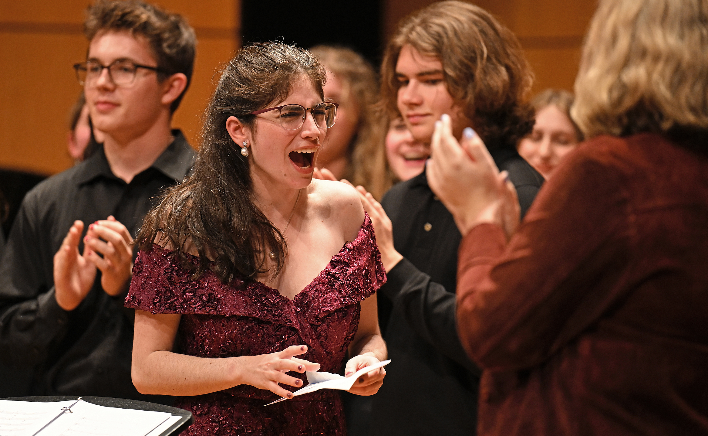 A student singer reacts after being named winner of a competition.