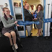 Student Accessibility Services staff and fellows help John Sharon '86 cut the ribbon to official open Conn's Disability Cultural Center.