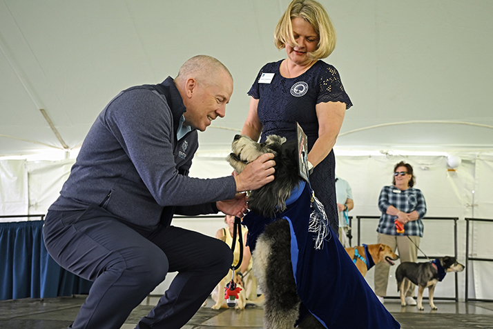 MC and Dean of Admission Andy Strickler pets First Dog Koda