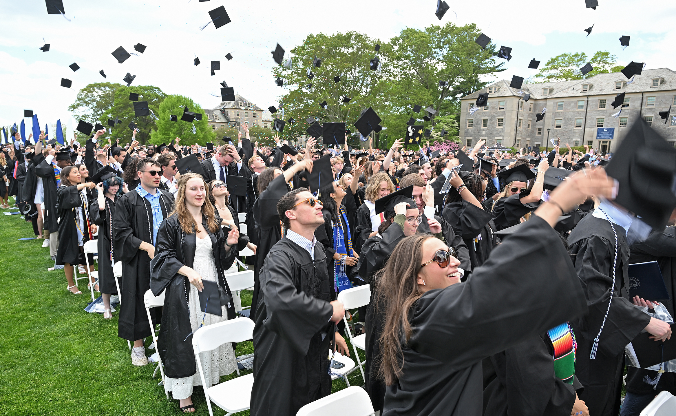 Graduates toss their caps in the air at the conclusion of commencement exercises.