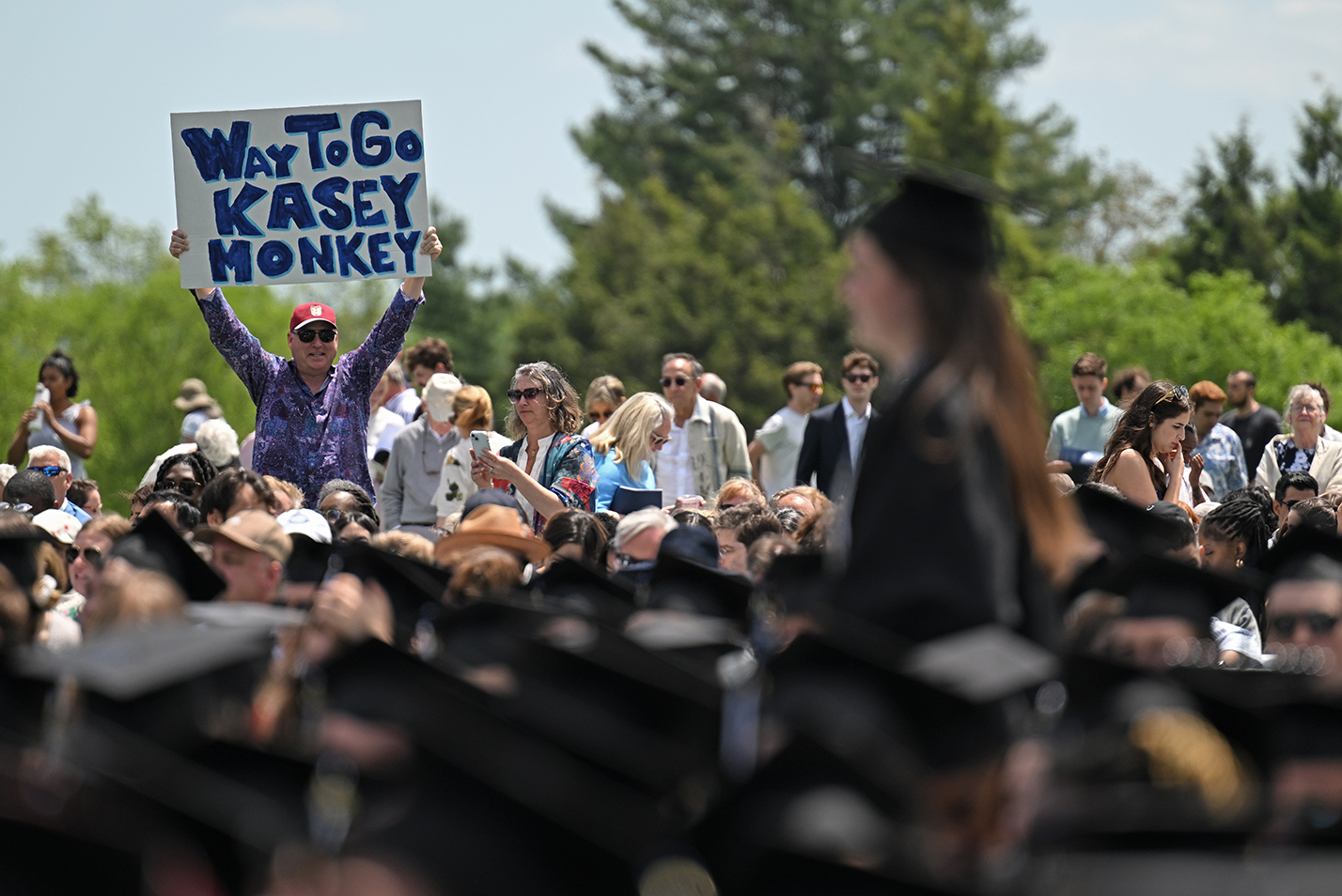 A family member holds up a sign reading 