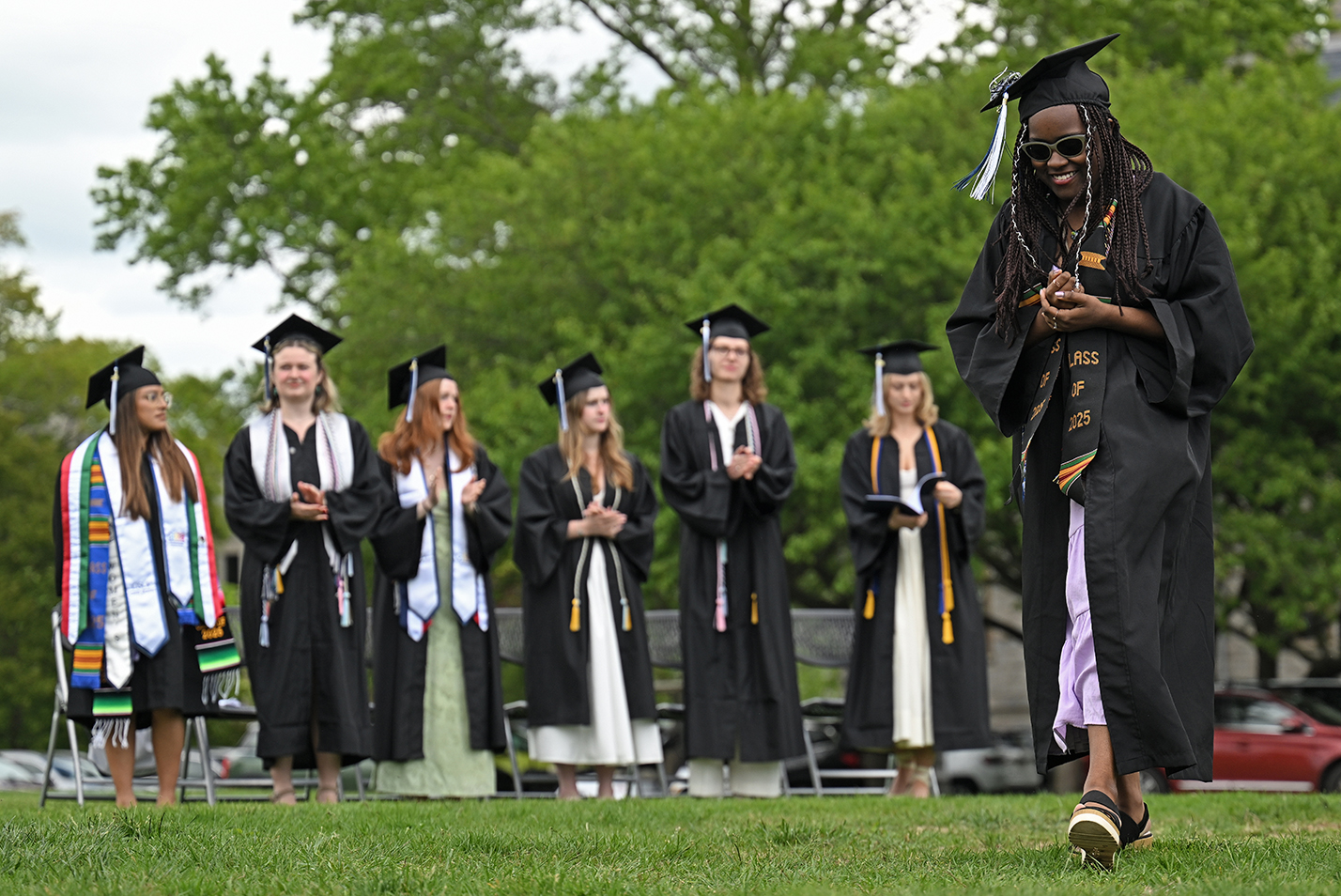 A graduate makes her way across the stage to receive her diploma during commencement exercises.