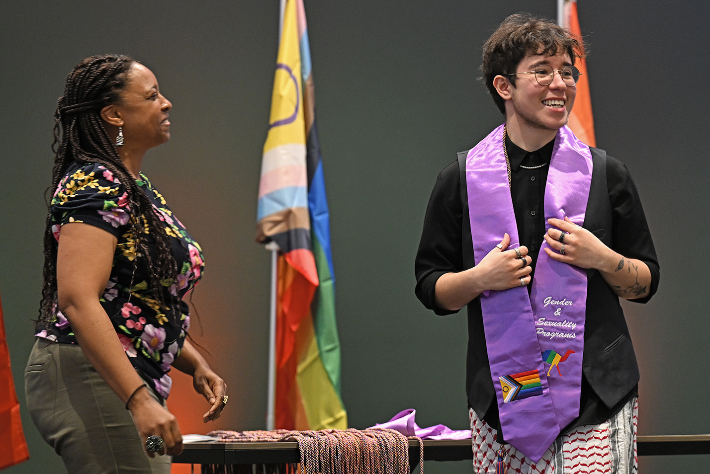 A student reacts after receiving their lavender stoll during a ceremony.
