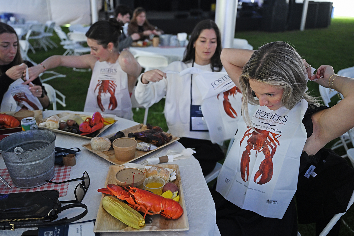 Diners at a lobster bake don their bibs before eating.