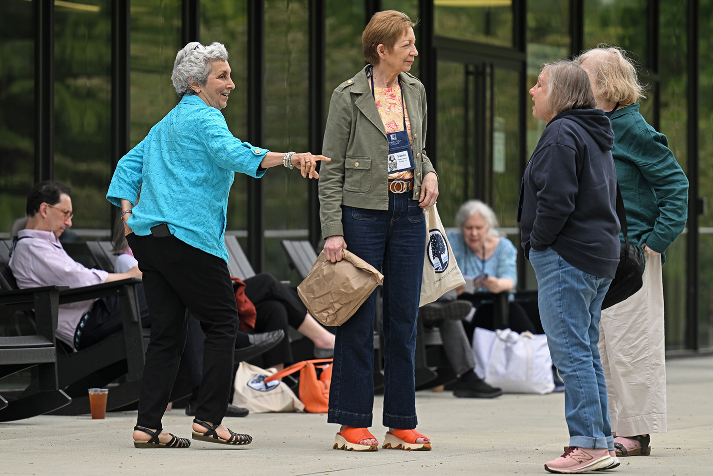 People converse standing on a patio