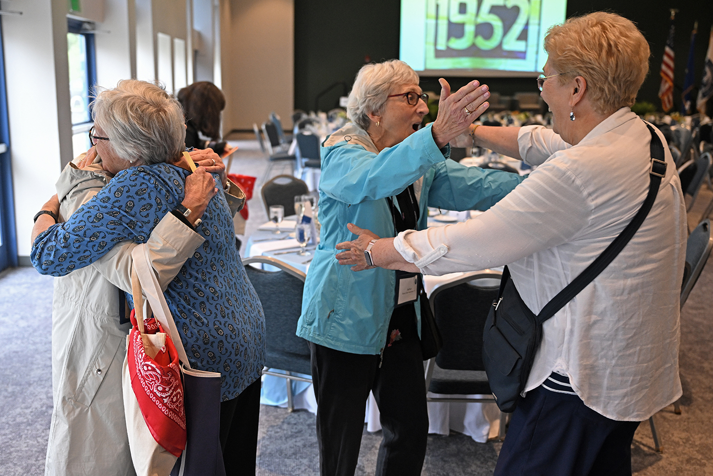 people embrace at a college reunion