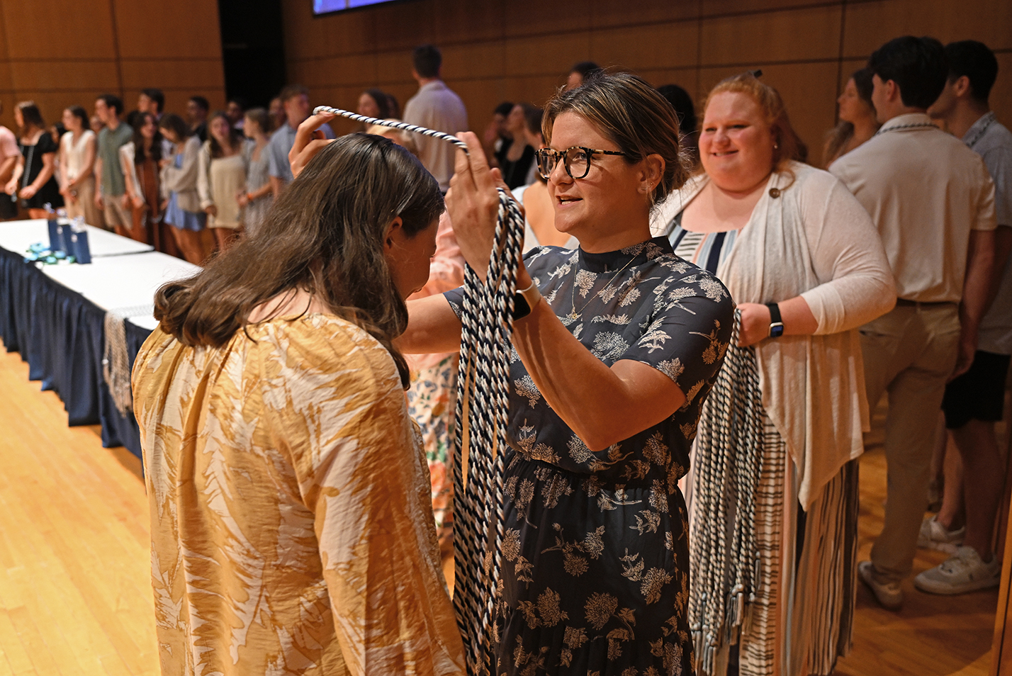 Student athletes are bestowed with honor cords for their upcoming graduation.