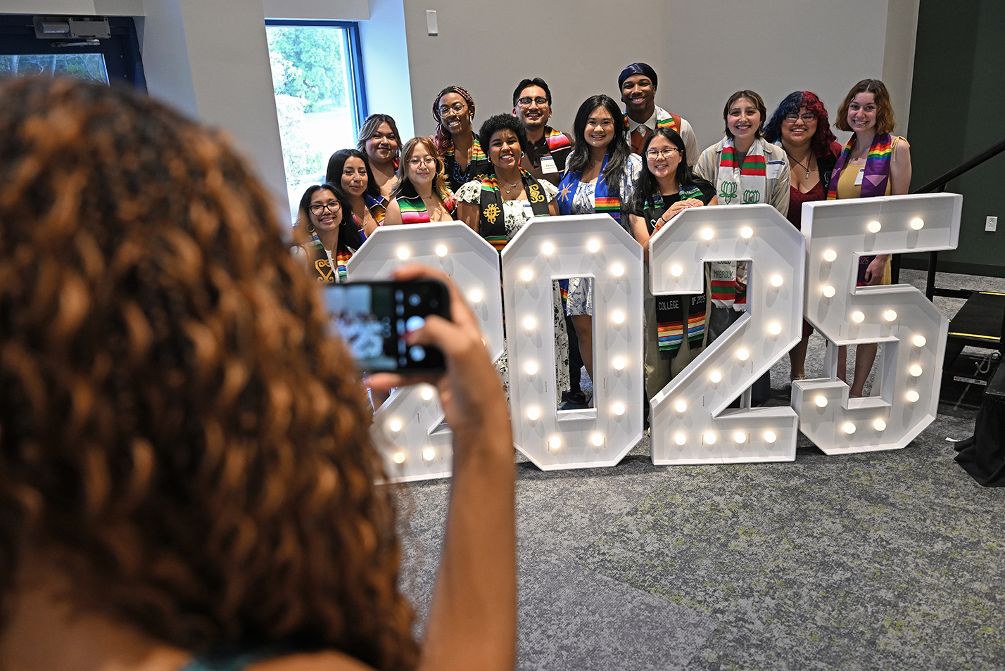 Students pose for a photo behind giant 2025 numbers.