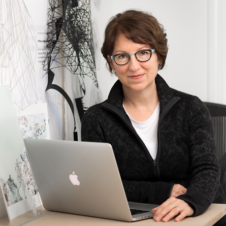 Andrea Wollensak sits at her computer.