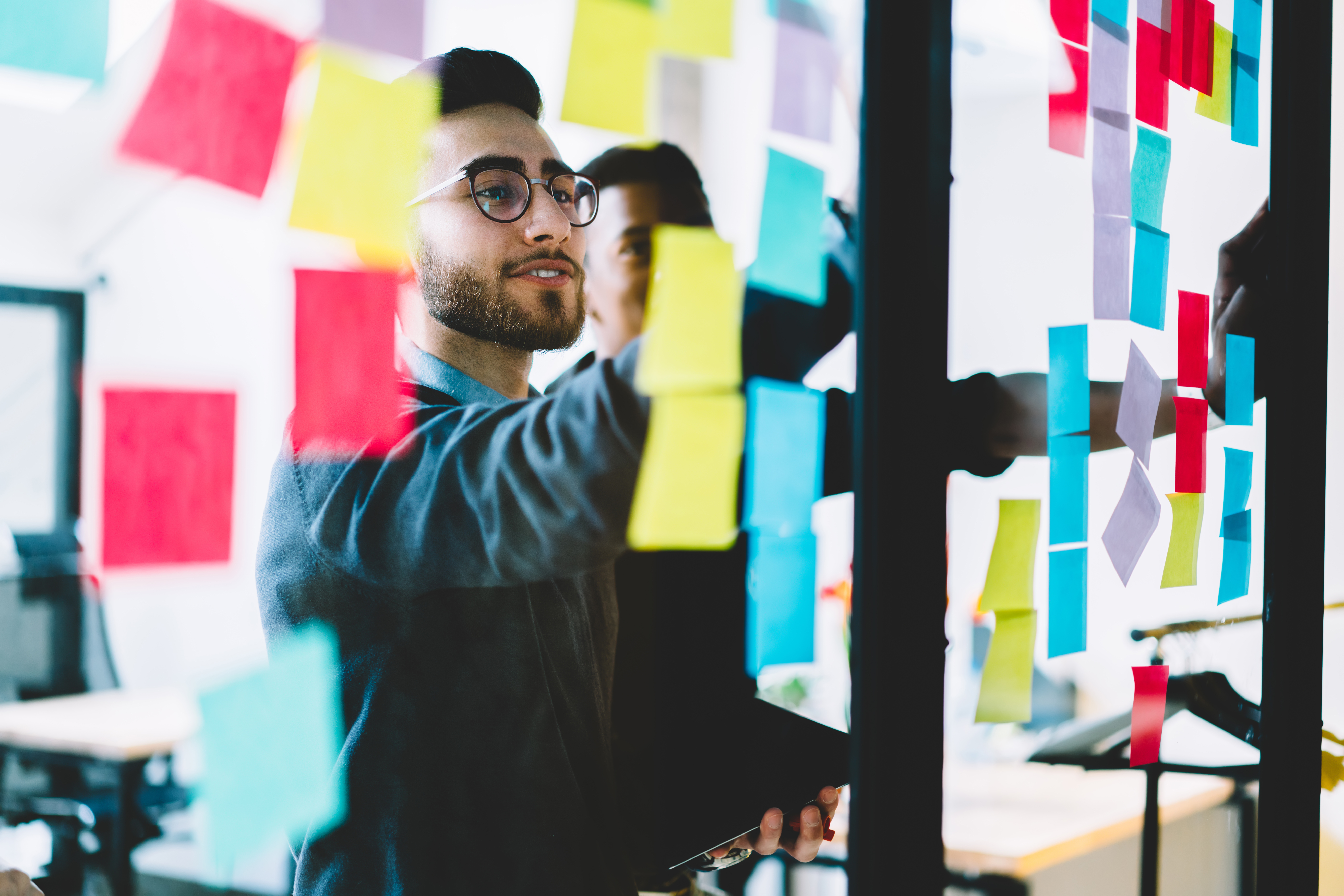Figure looks over a board full of sticky notes