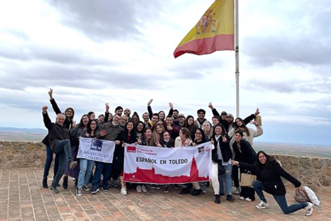 Group of students holding flags in Toledo, Spain